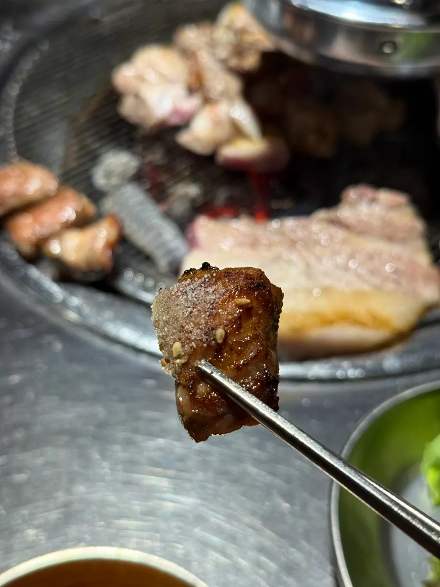 A golden-brown piece of grilled pork neck