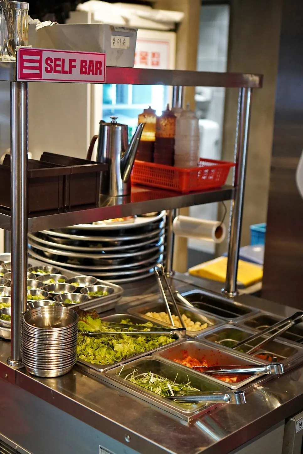 Wrap vegetables and sauces at the self-serve bar