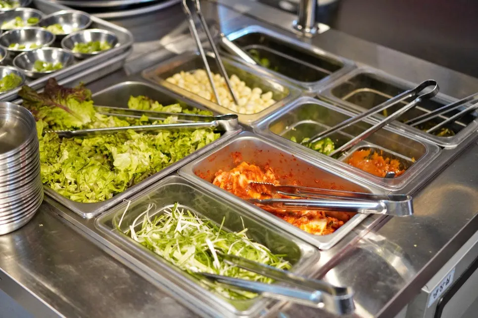 Side dishes with lettuce and perilla leaves at the self-serve bar