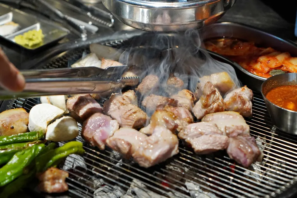 Sliced pieces of teukmokssal on the grill