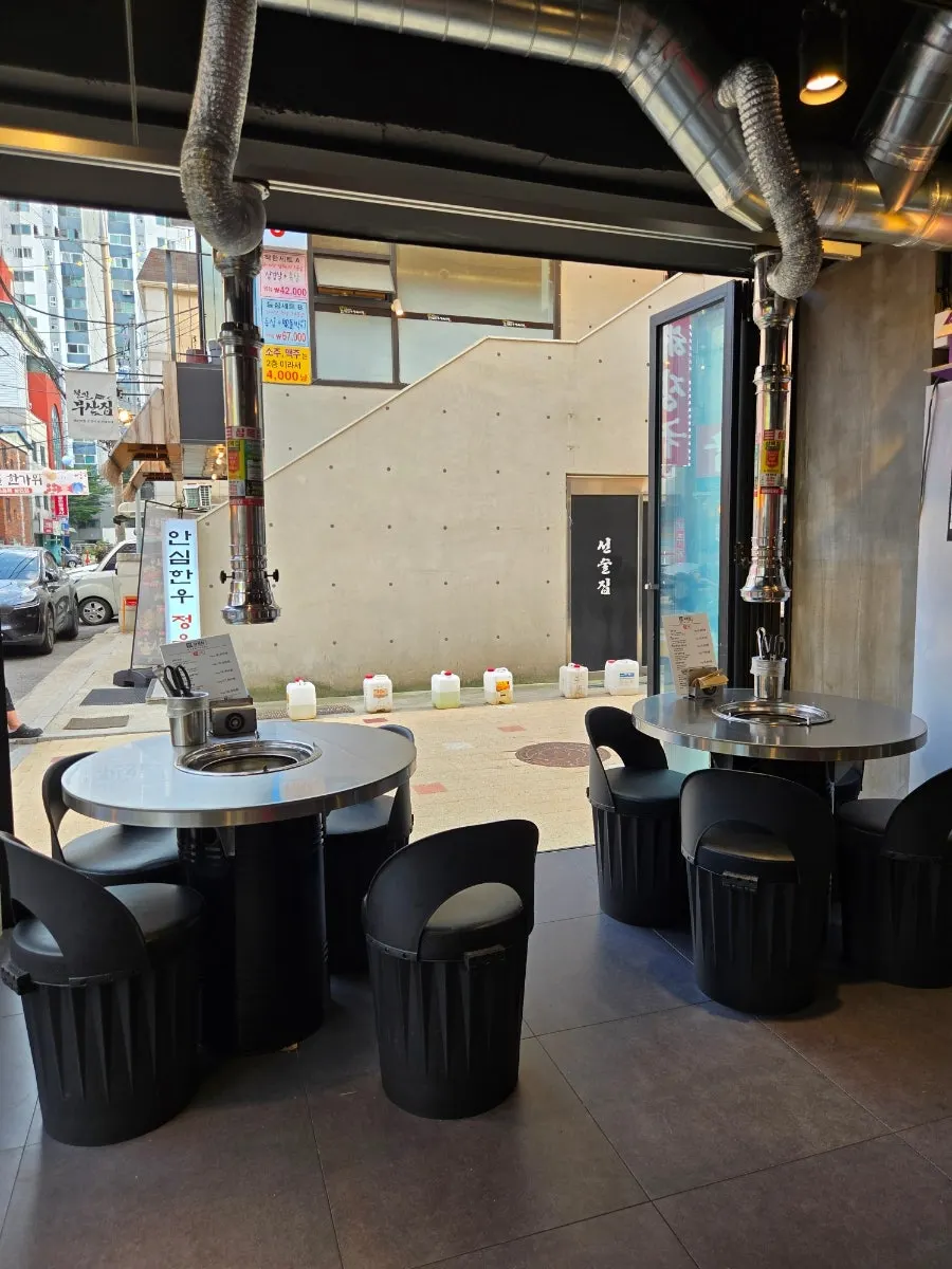 Interior of Sammokjip with charcoal grill tables