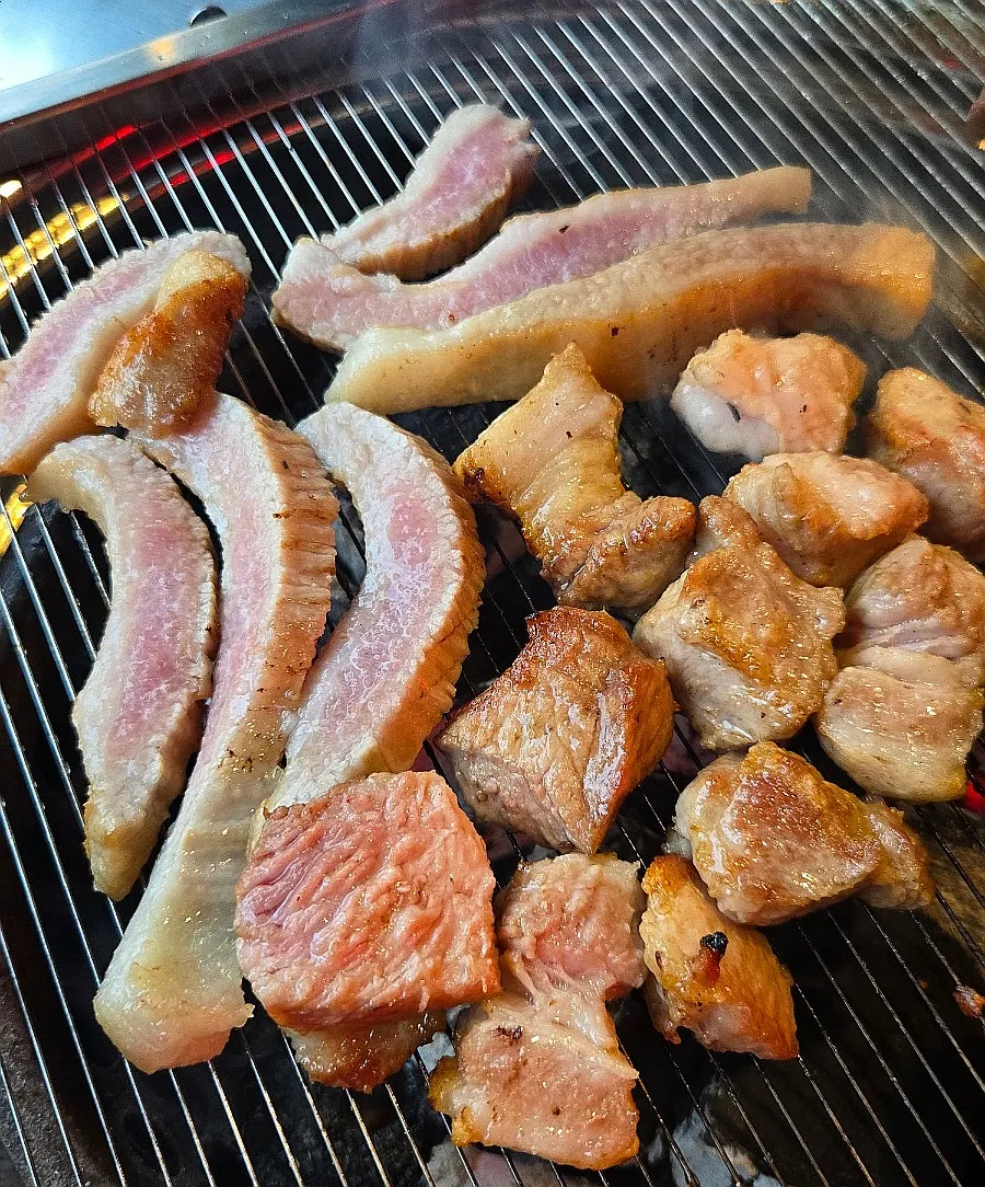 Samok tonghangjeongsal placed on the charcoal grill