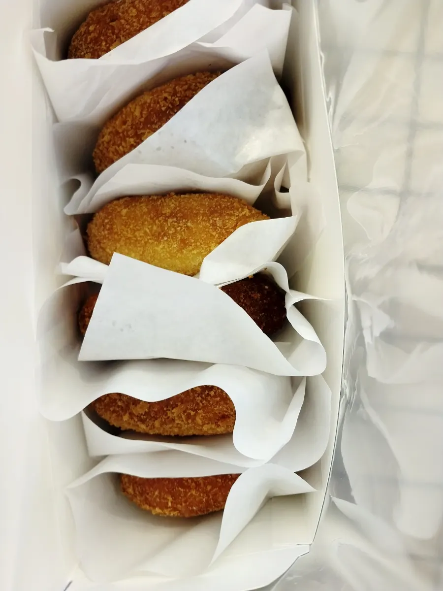 Box of six croquettes left open to release steam