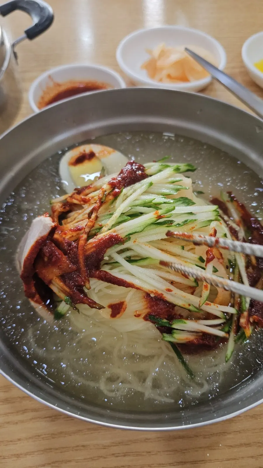 Scooping up the water milmyeon broth