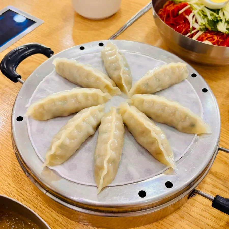 A plate of dumplings served alongside milmyeon