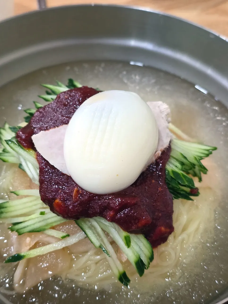 Mul-milmyeon with icy broth and cucumber topping