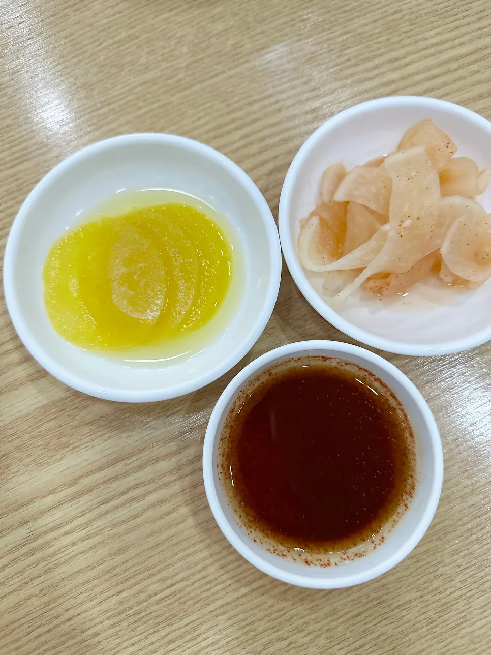 Basic side dishes: pickled radish, sliced radish, and soy sauce for dumplings