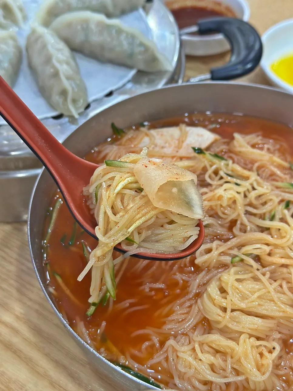 Springy milmyeon noodles lifted with chopsticks