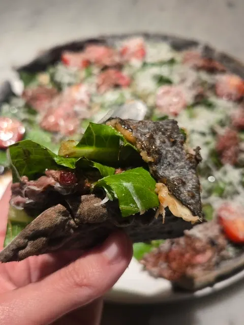 Steak pizza piled high with cheese topping
