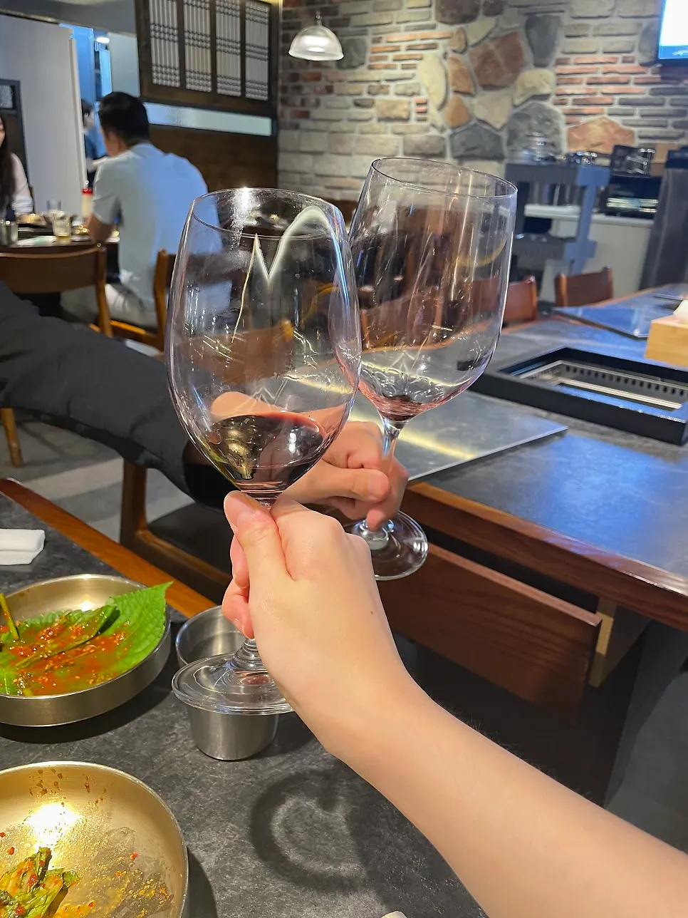 Red wine poured into a chilled glass with an opener