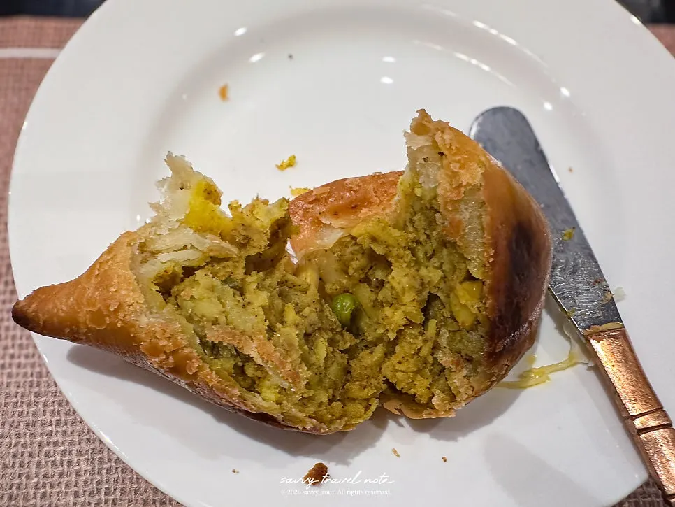 Samosa, an Indian fried dumpling, served with sauce
