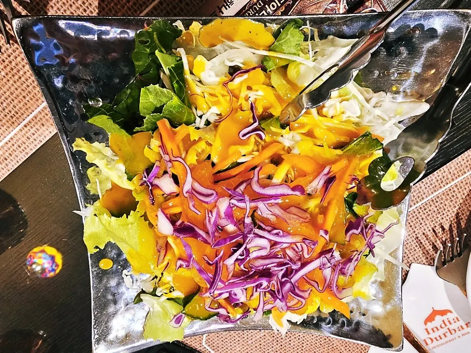 A generous green salad with mango sauce