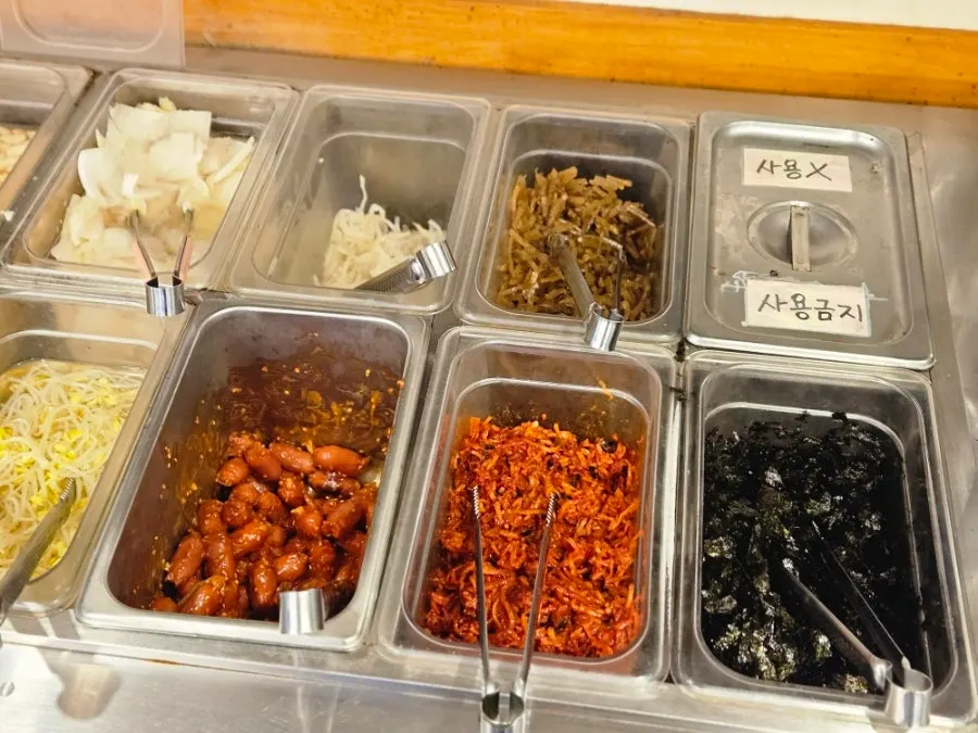 A bowl of seaweed soup with side dishes