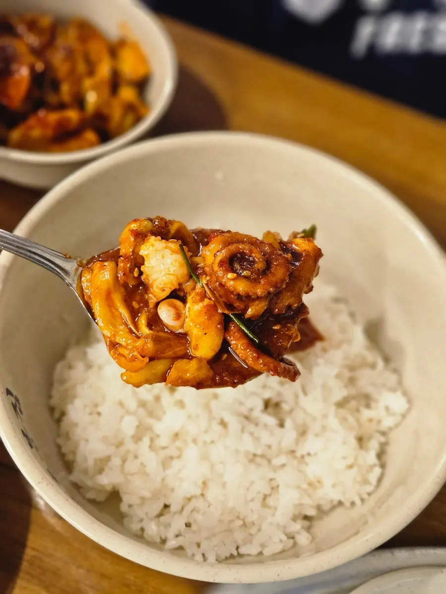 Octopus bibimbap mixed with sesame oil and seaweed flakes
