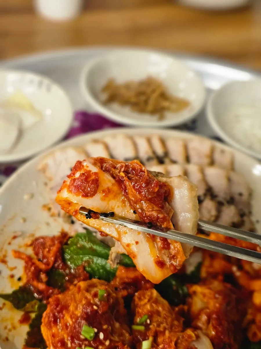 A bite of bossam wrapped in geotjeori