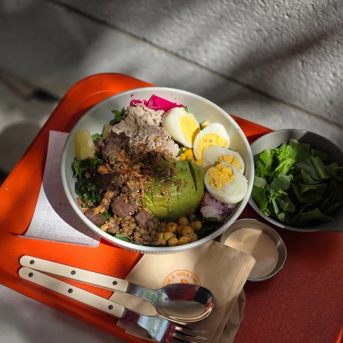 A bowl of poke on the outdoor terrace at Ola Poke Samseong Branch near Samseong Station