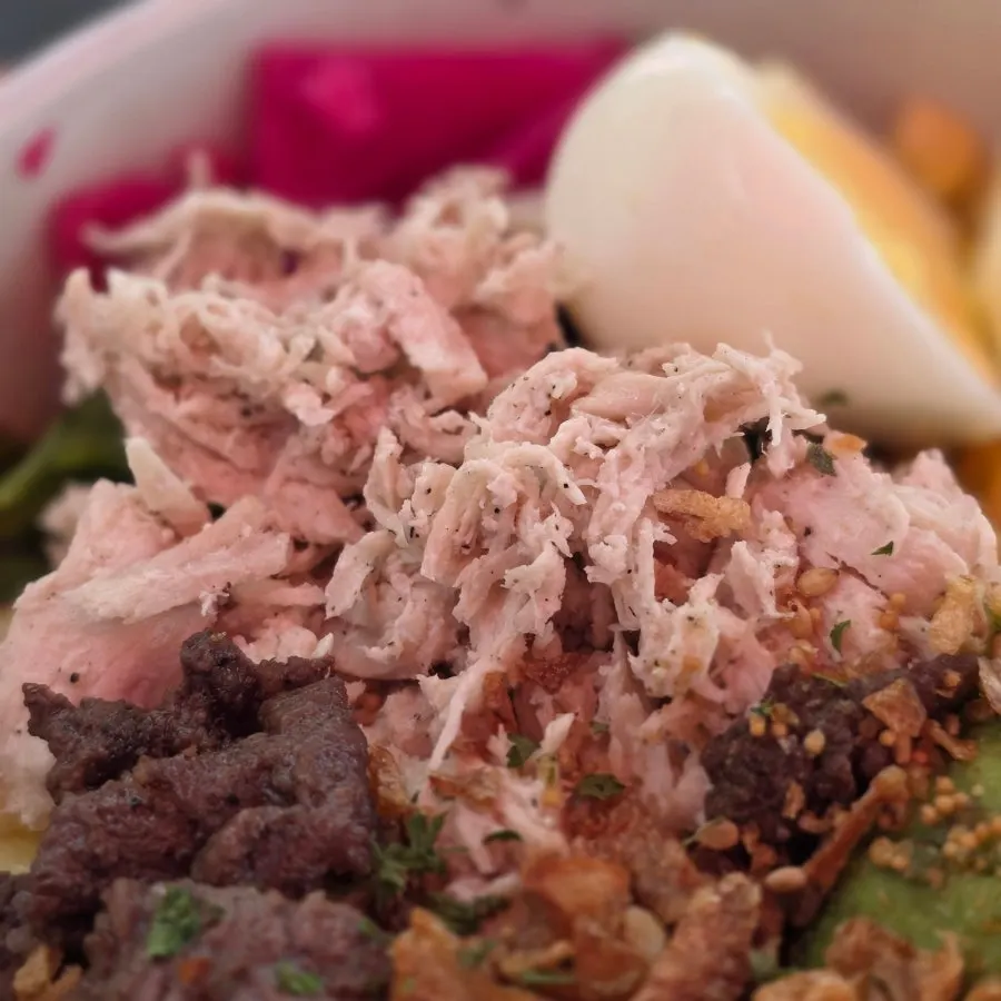 Shredded chicken breast topping on the poke bowl