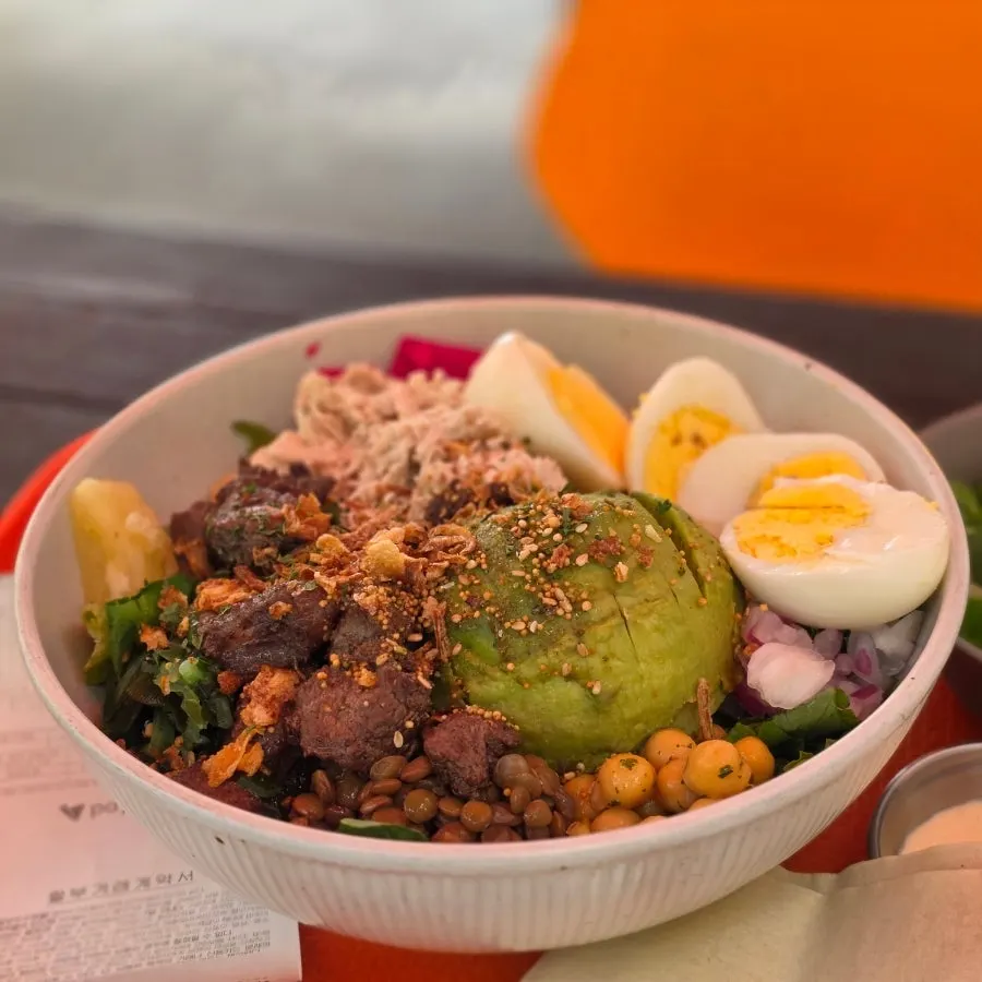 A lunch bowl at Ola Poke fully loaded with toppings