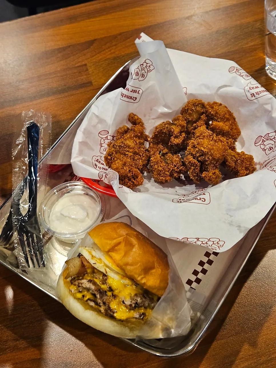 Greed Burger and Crunch Chicken served at the table
