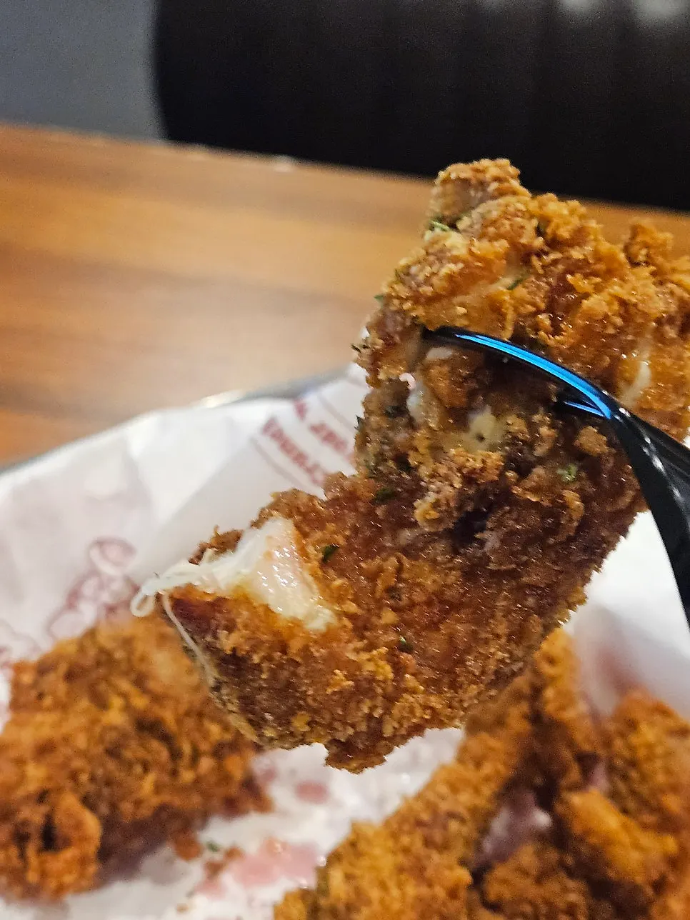 Close-up of the Greed Burger with only meat and cheese remaining
