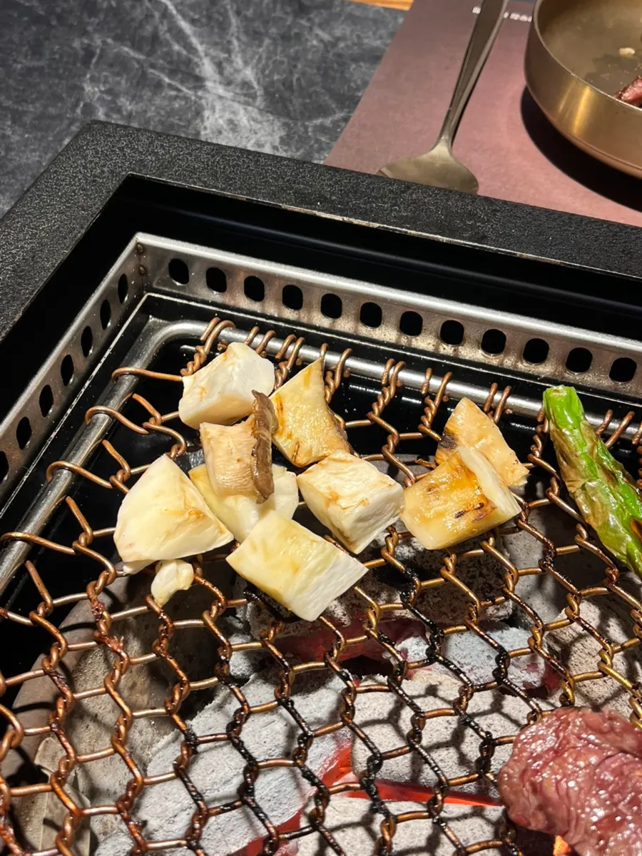 Mushrooms grilled over charcoal as a side