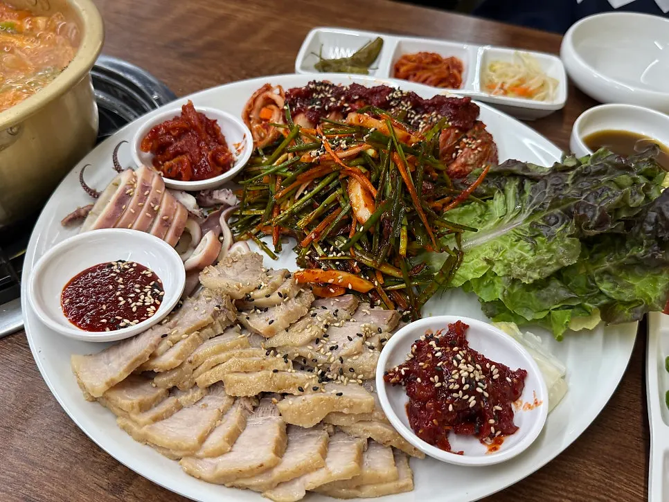 A plate of squid bossam served with bossam kimchi