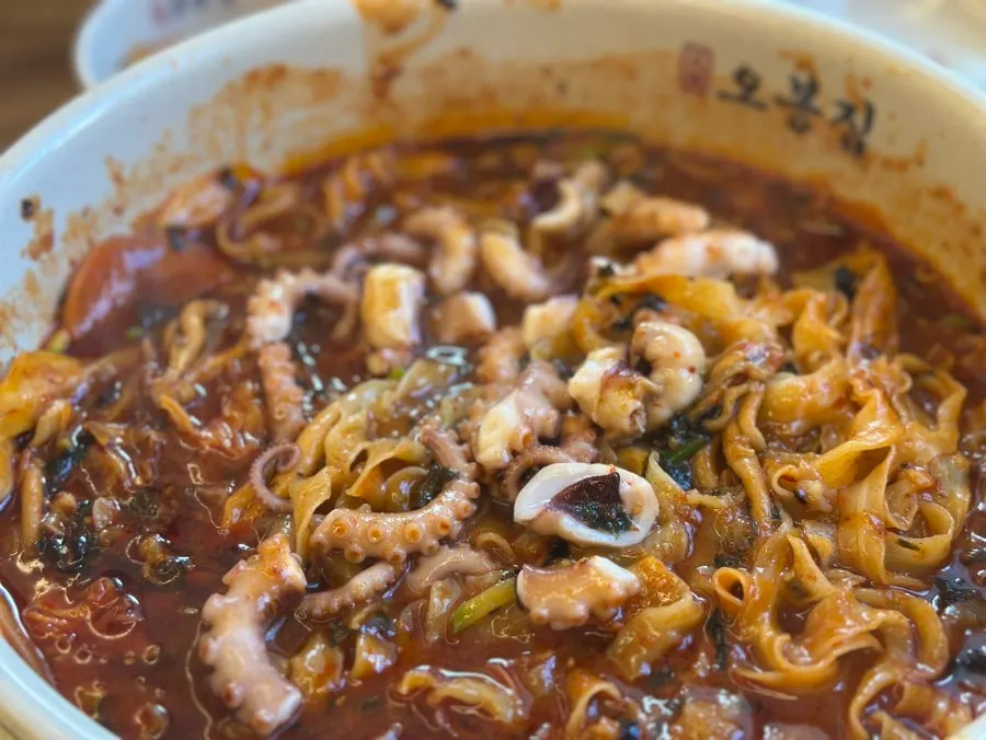 Kalnakji with a whole octopus visible in the bowl