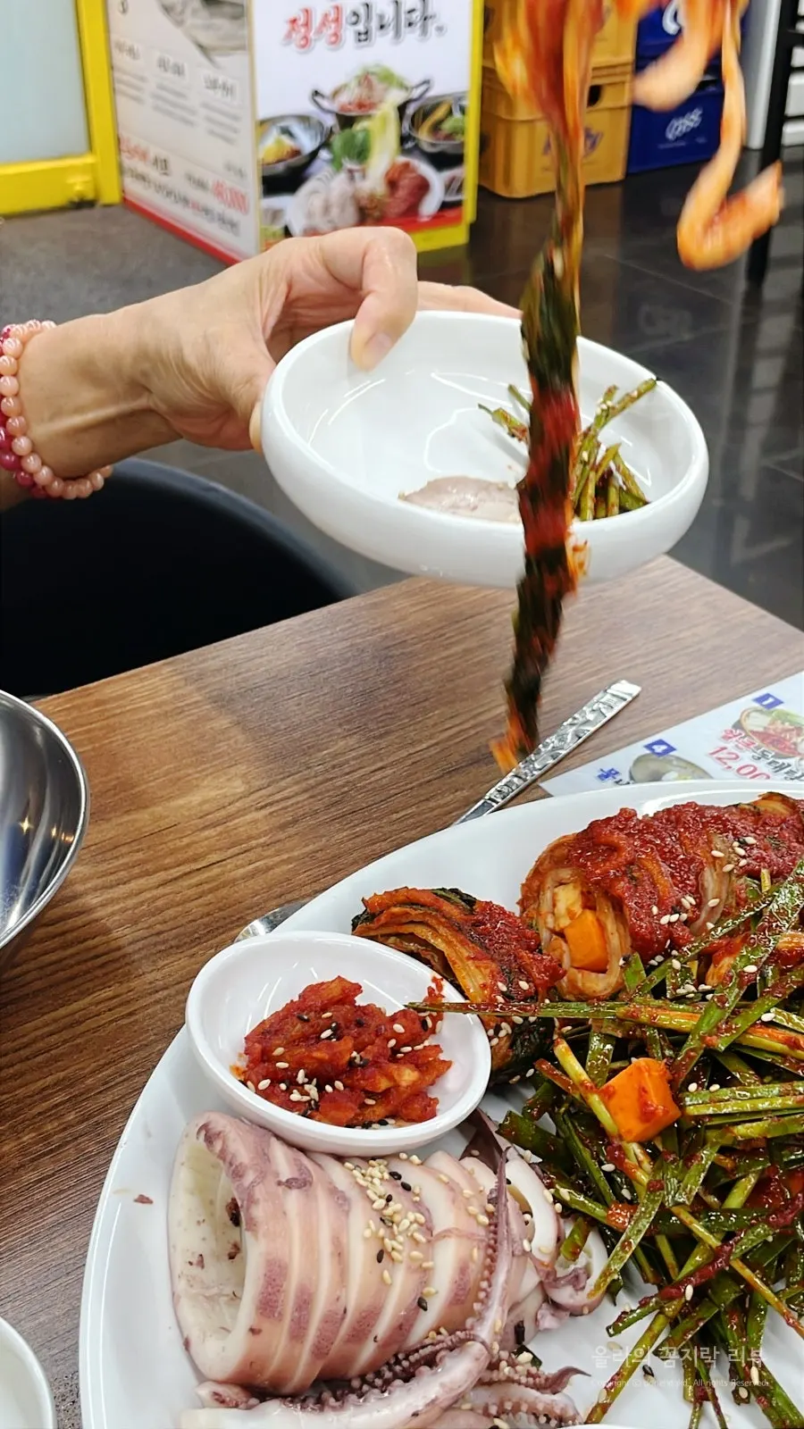 A piece of boiled pork topped with chive salad