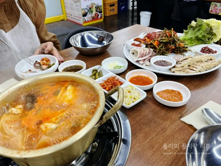 Squid bossam served alongside banchan