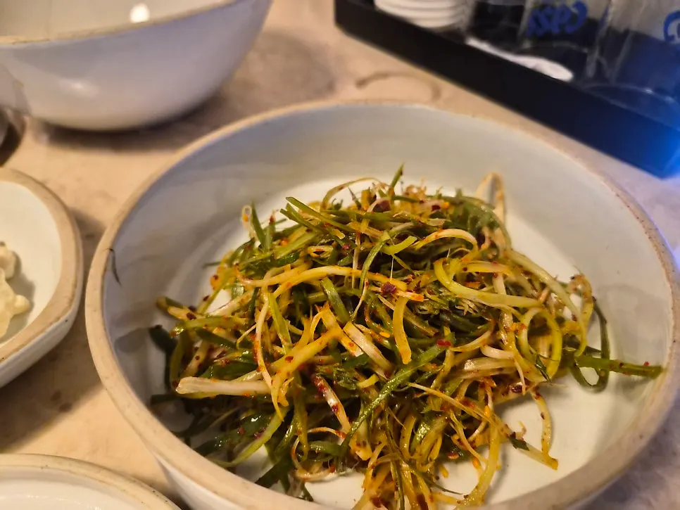 Meat side dishes including japchae and scallion salad