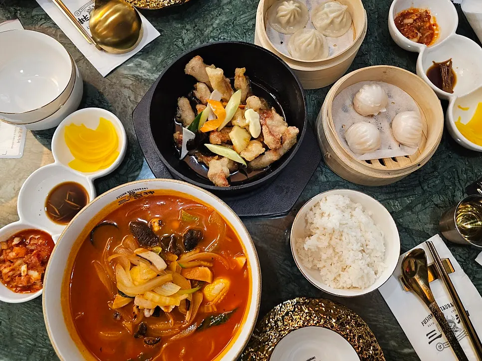 The four dishes ordered for two at Samsin Garosu-gil, laid out on the table