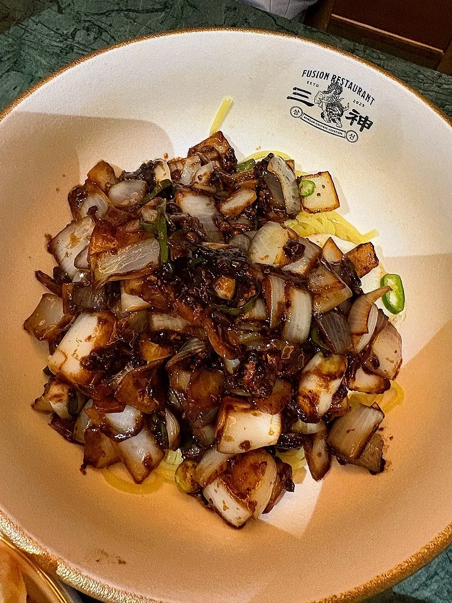 Yuni-gochu ganjjajang noodles topped with a fried egg