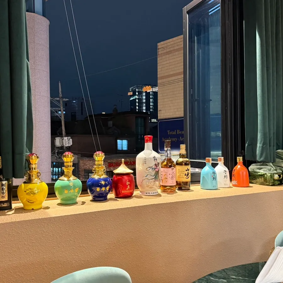 Partitioned tables with Chinese liquor displayed by the window