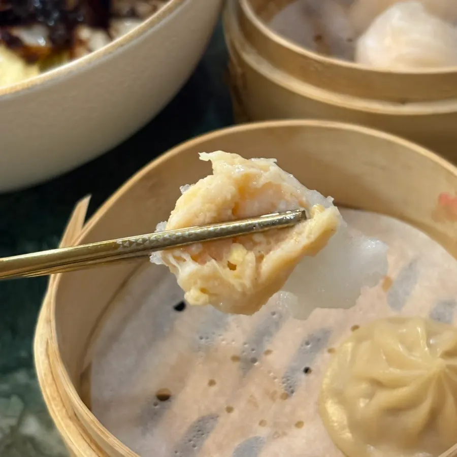 Handmade shrimp har gow with shrimp visible through the translucent wrapper