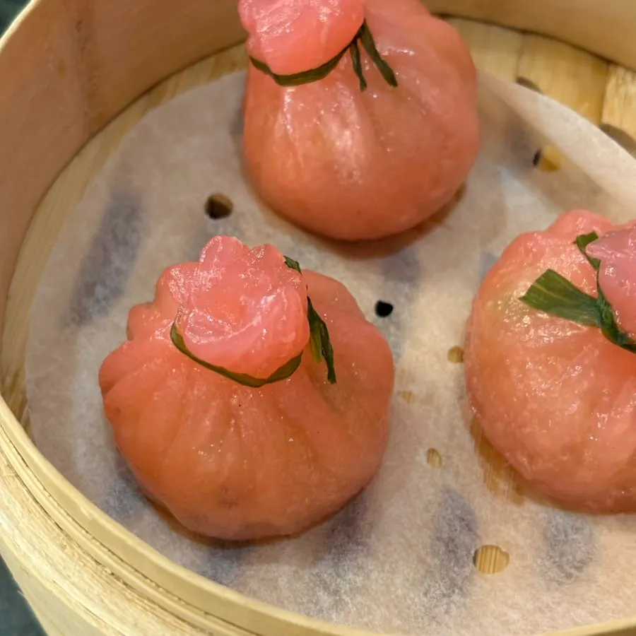 Pink wedding shaomai revealed under the opened steamer lid