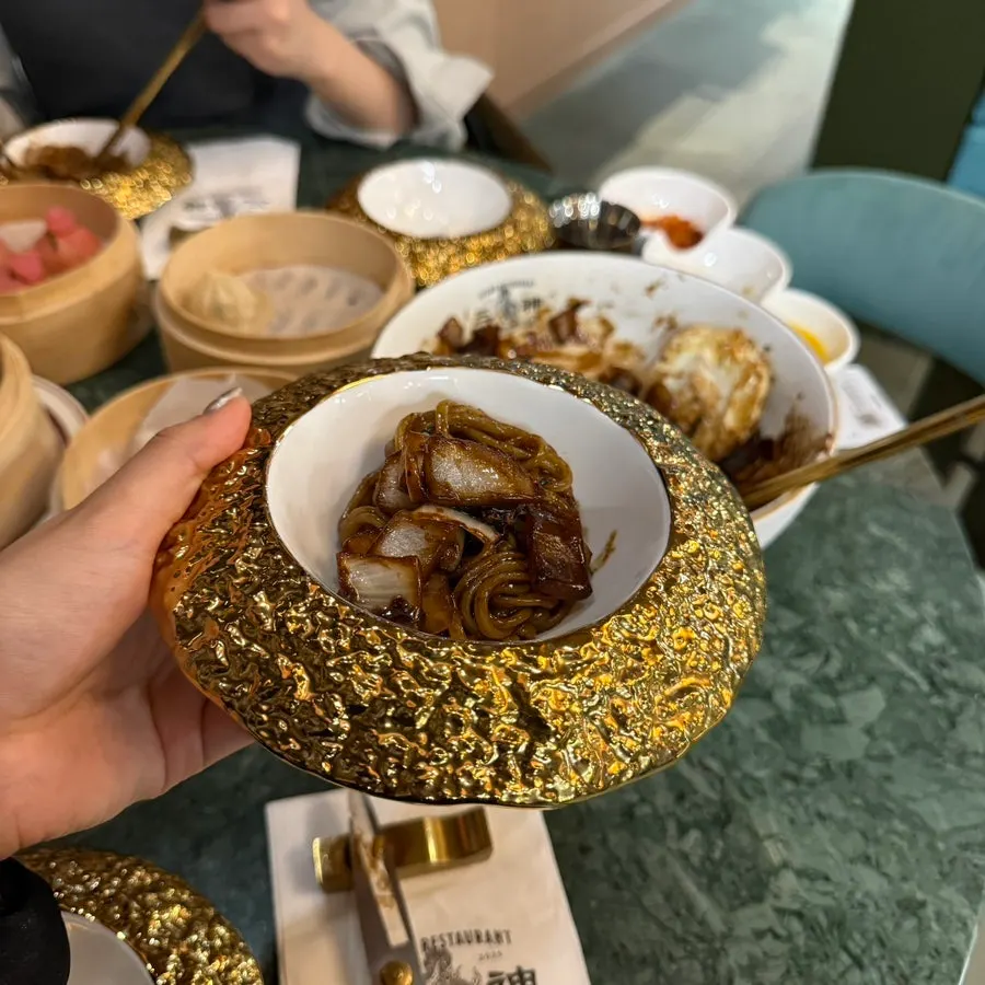 A bite of jajangmyeon twirled onto chopsticks