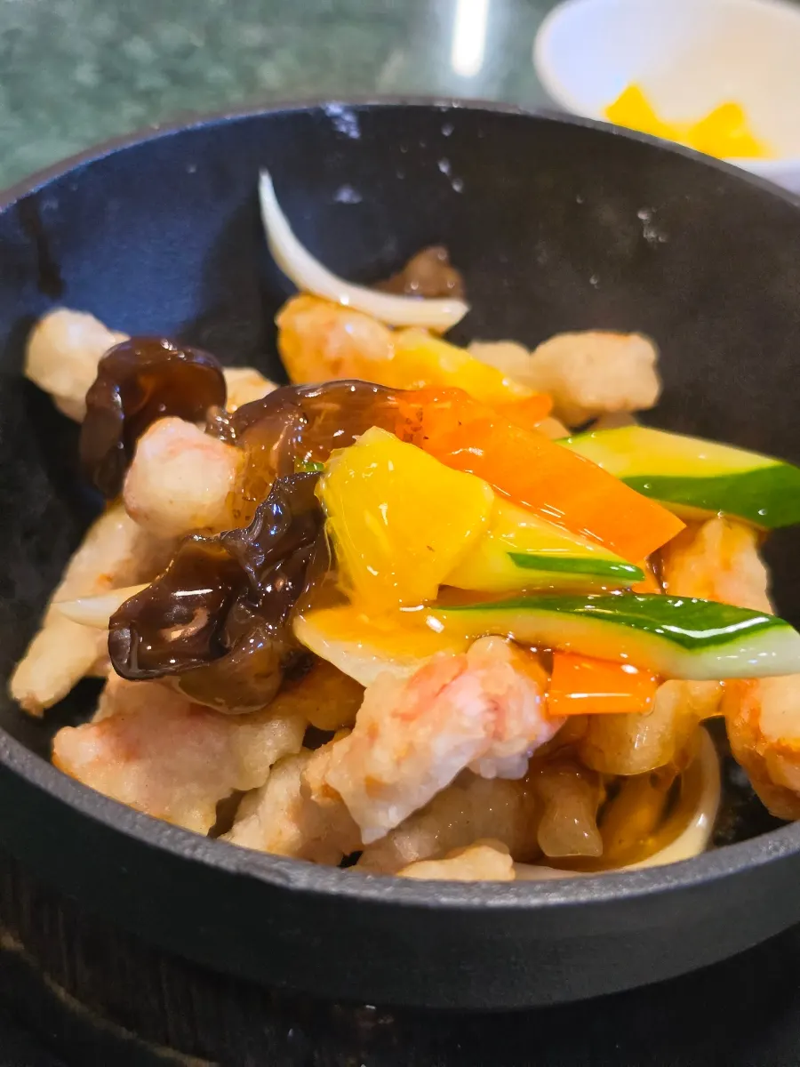 Three side dishes: pickled radish, soy sauce, and onion salad