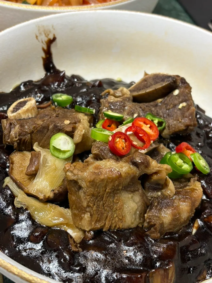 Close-up of galbi-jjim meat piled on the noodles