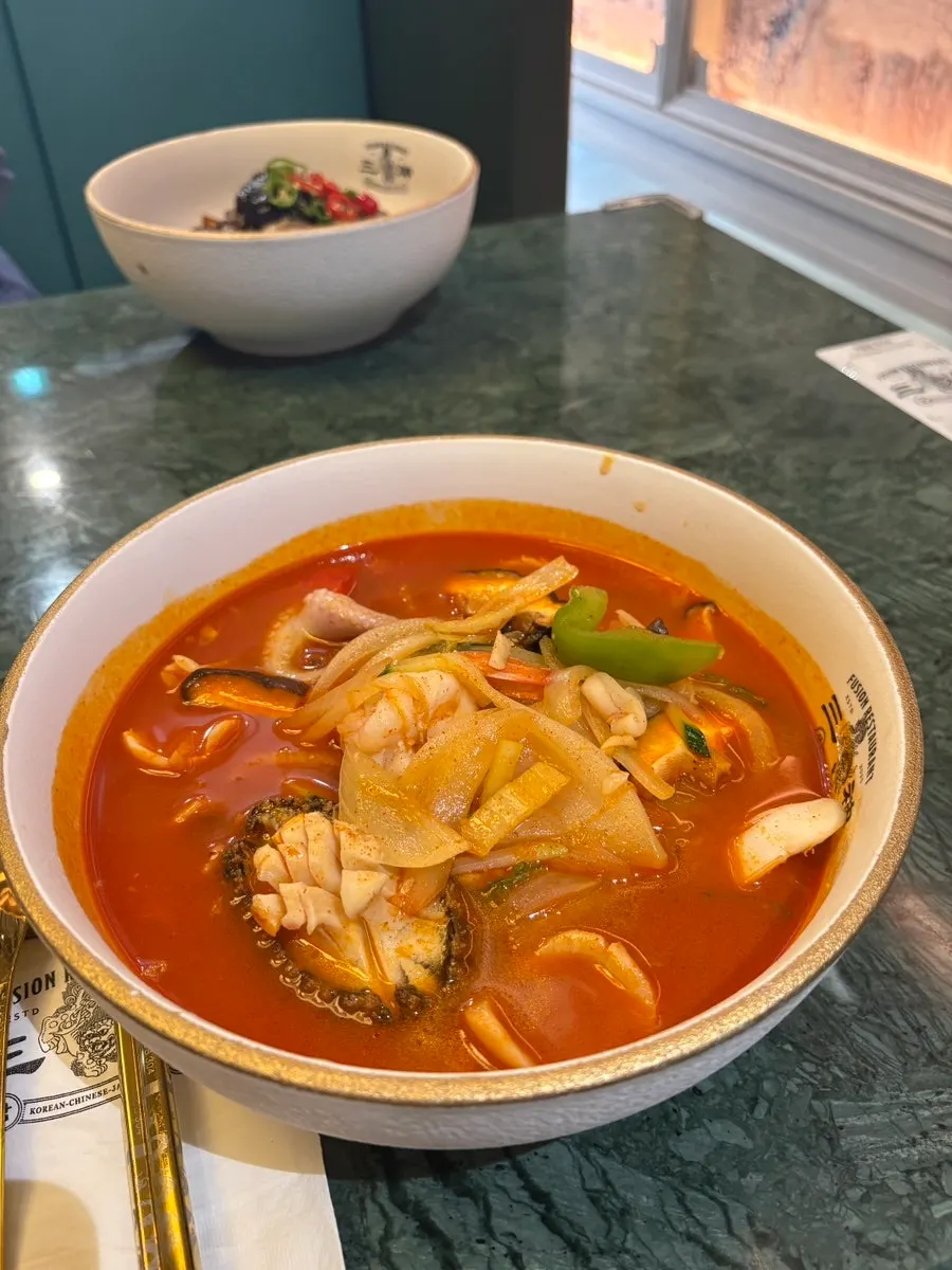 A bowl of imperial samseon jjamppong topped with abalone