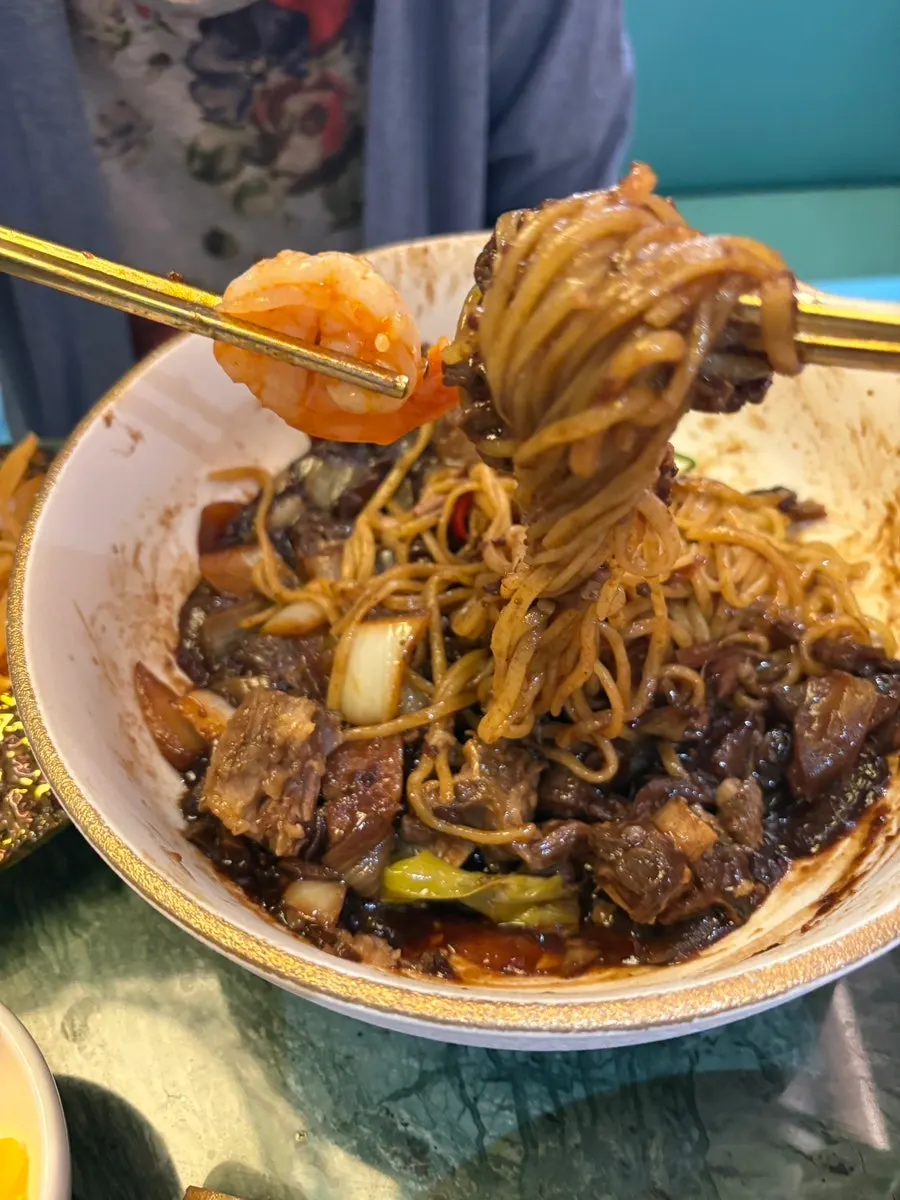A large shrimp on top of the jjamppong