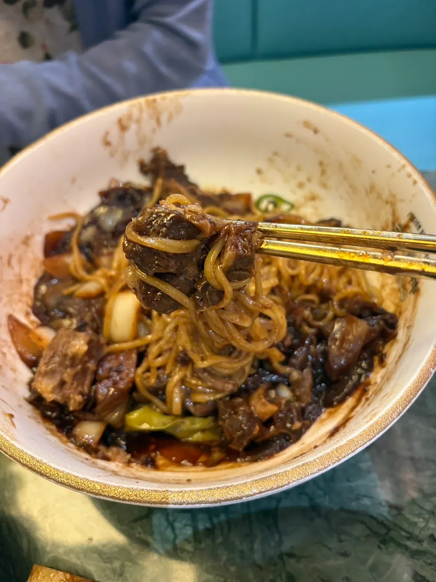 Noodles wrapped around a piece of galbi