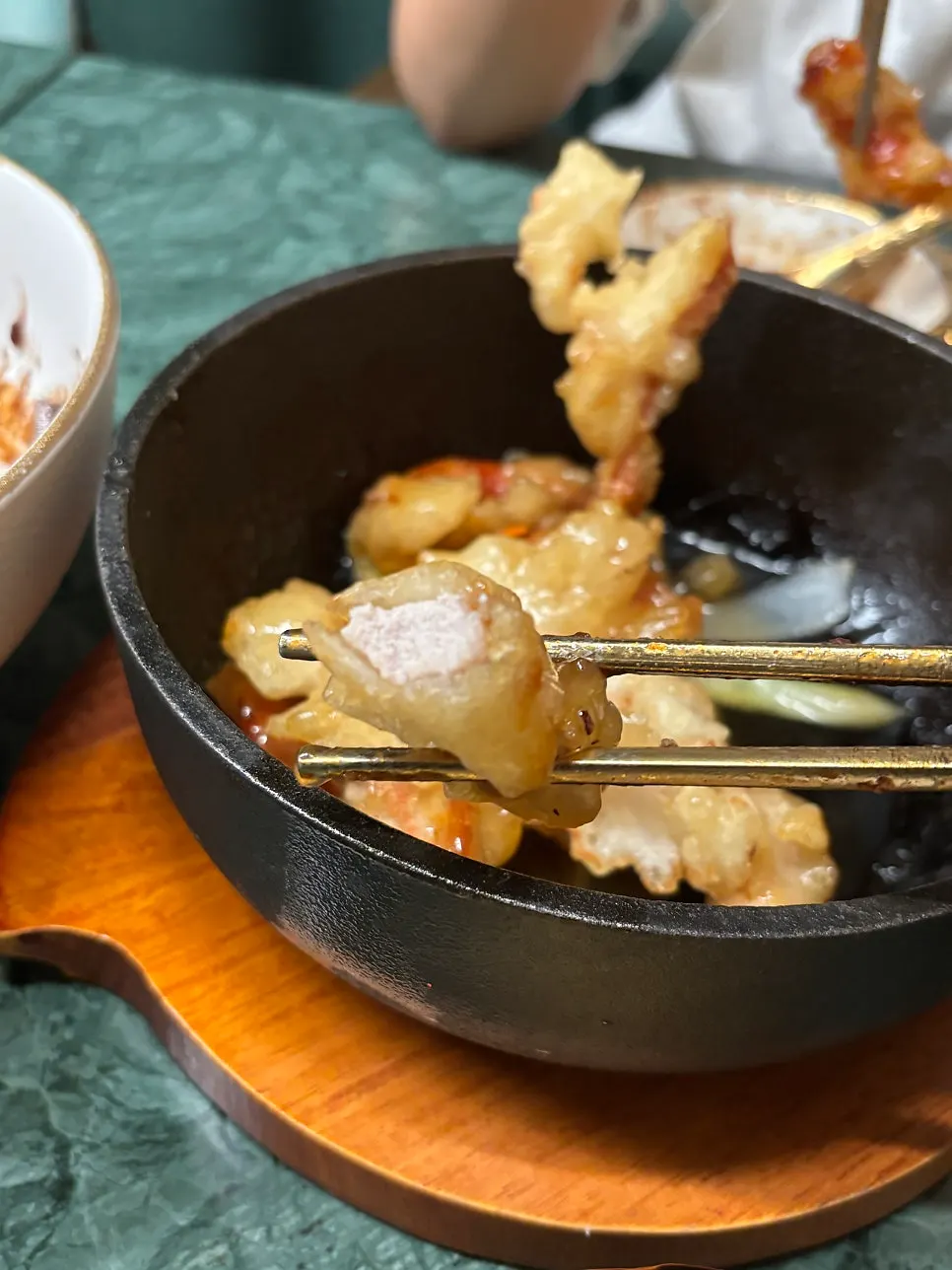 A piece of tangsuyuk showing the chunky meat and batter