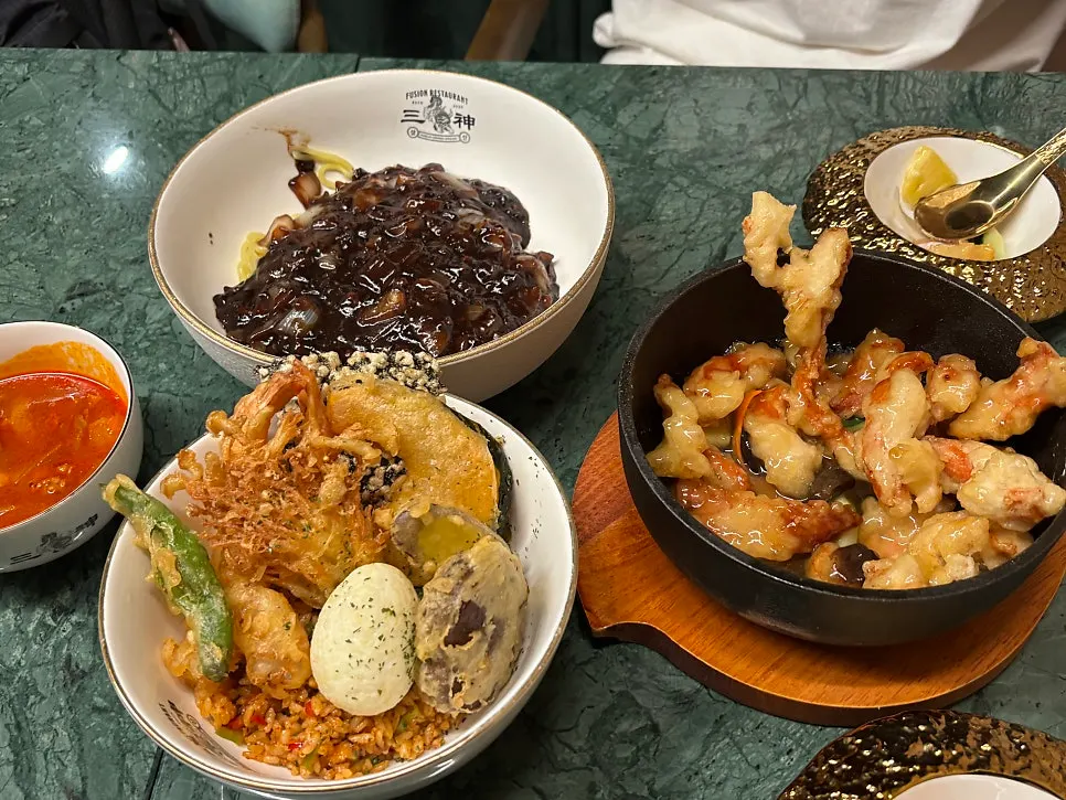 A spoonful combining kimchi fried rice and tempura