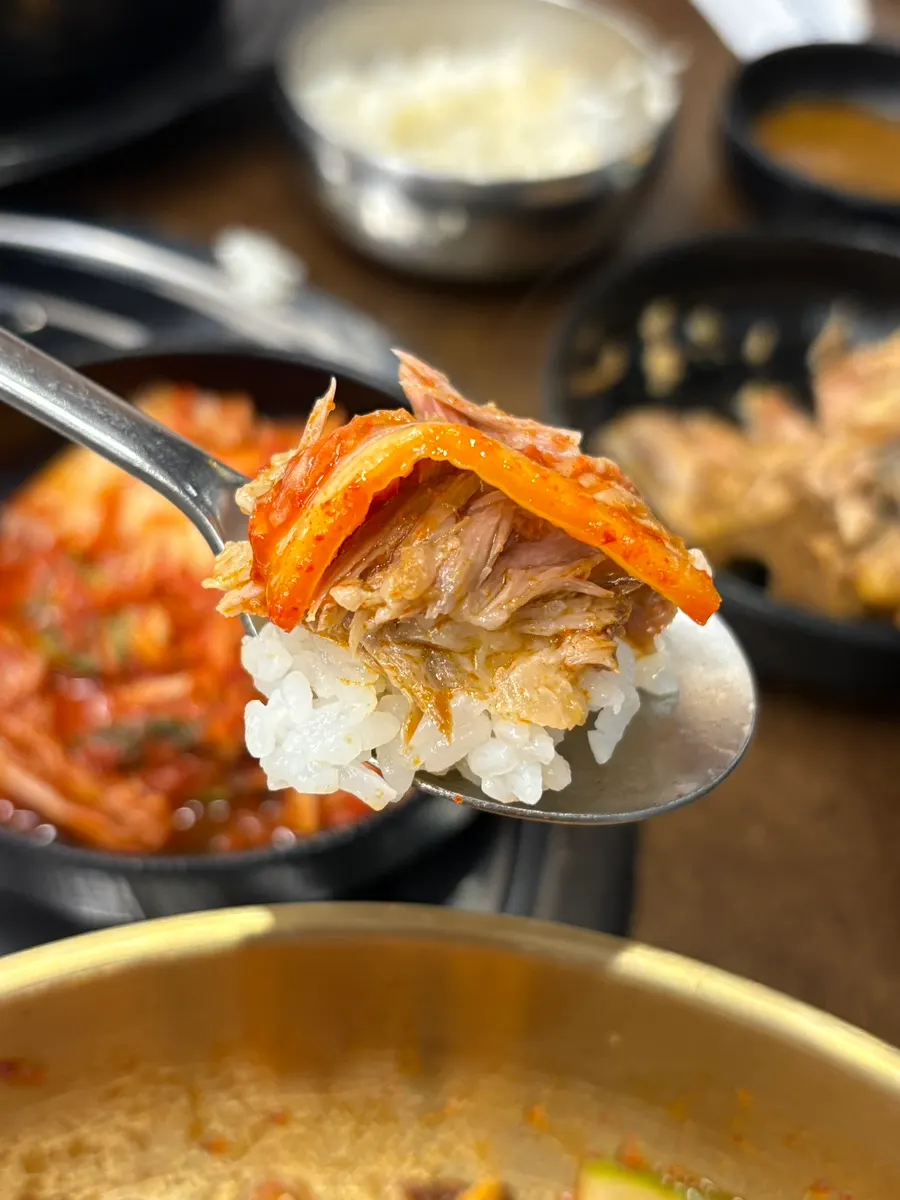 A piece of gamjatang meat placed on white rice