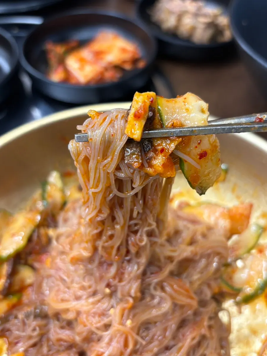 Noodles of bibim naengmyeon mixed with seasoning sauce