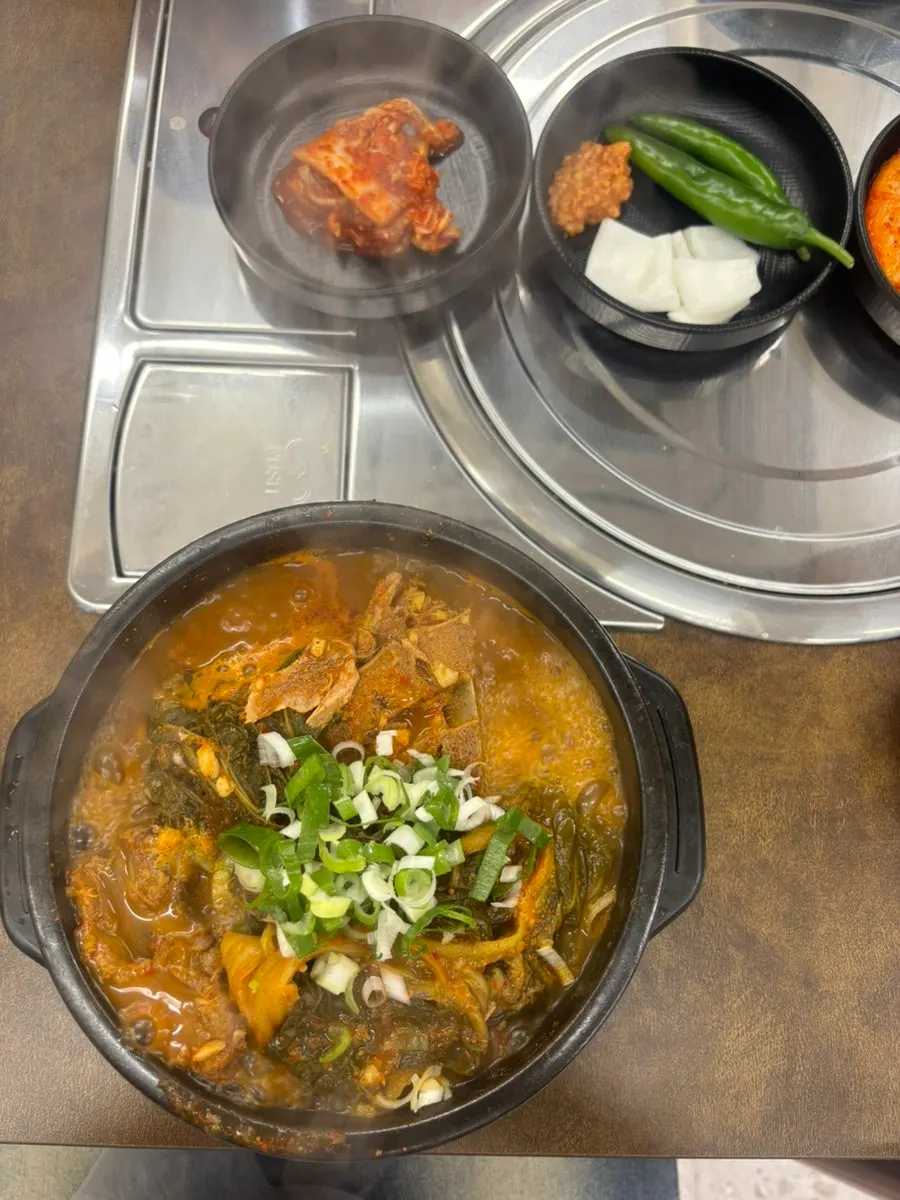 Bubbling pot of ugeoji bone soup served at the table
