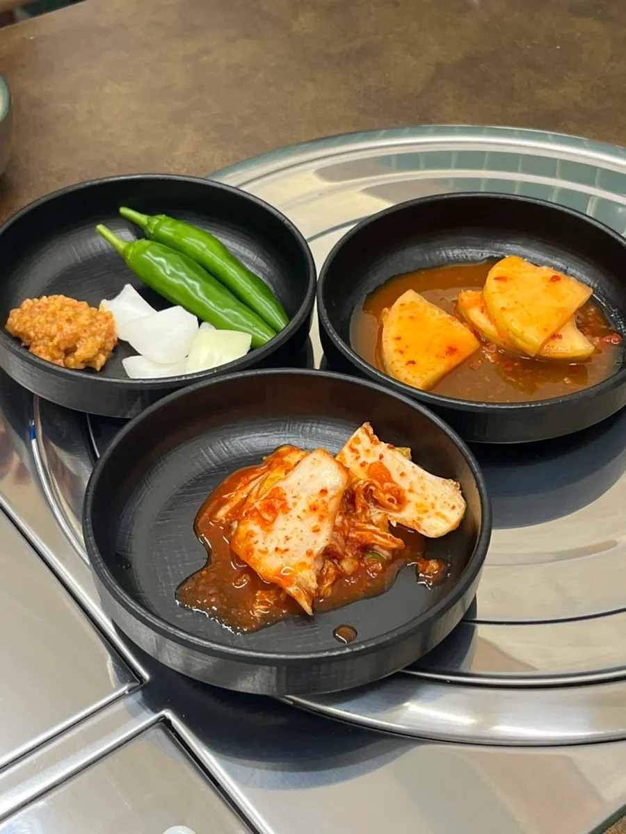 Fresh kimchi and diced radish kimchi taken from the self-serve bar