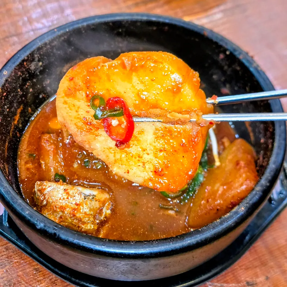 Radish and potato soaked in seasoning inside the cutlassfish stew