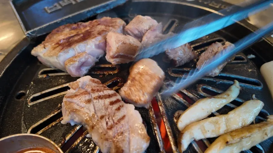 Pork belly cooking on the grill