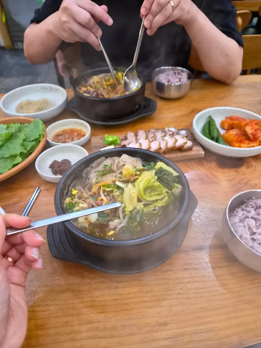Spoon lifting ingredients out of the haejangguk